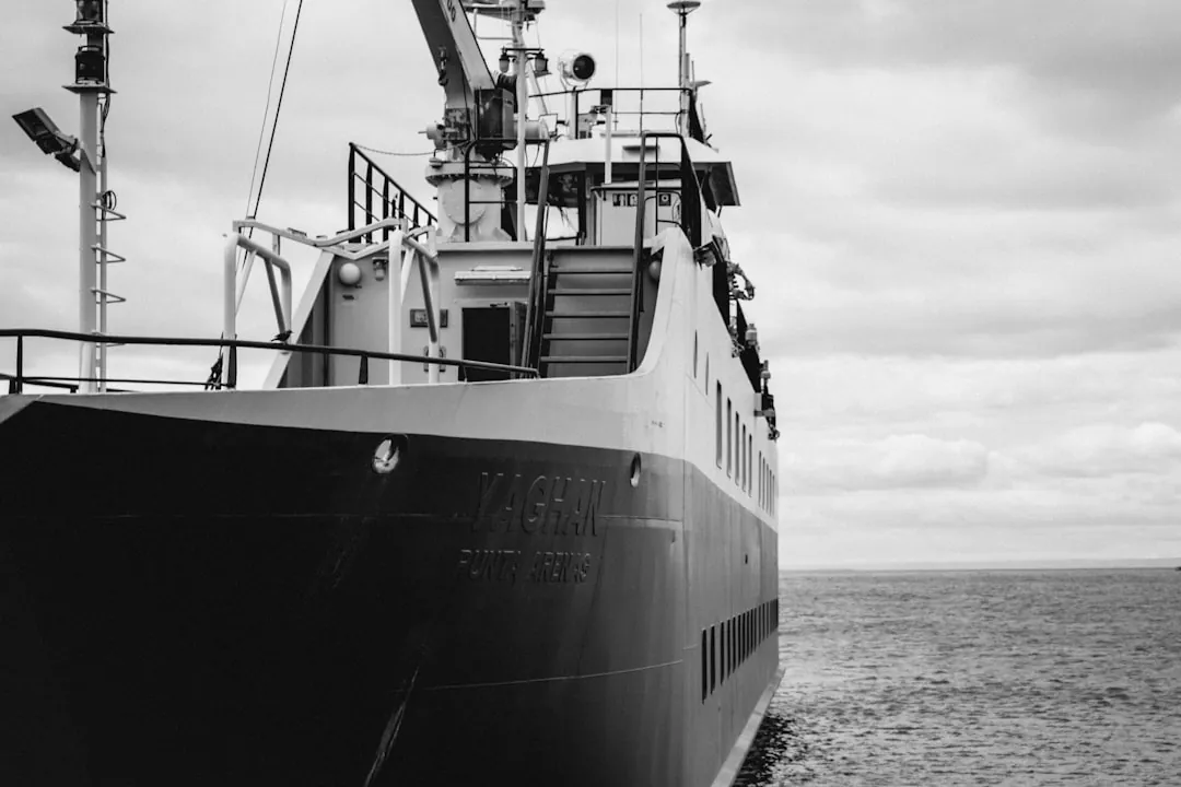 A black and white photo of a boat in the water
