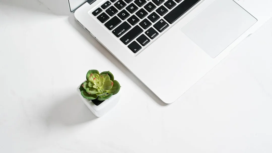 a laptop computer sitting on top of a white desk