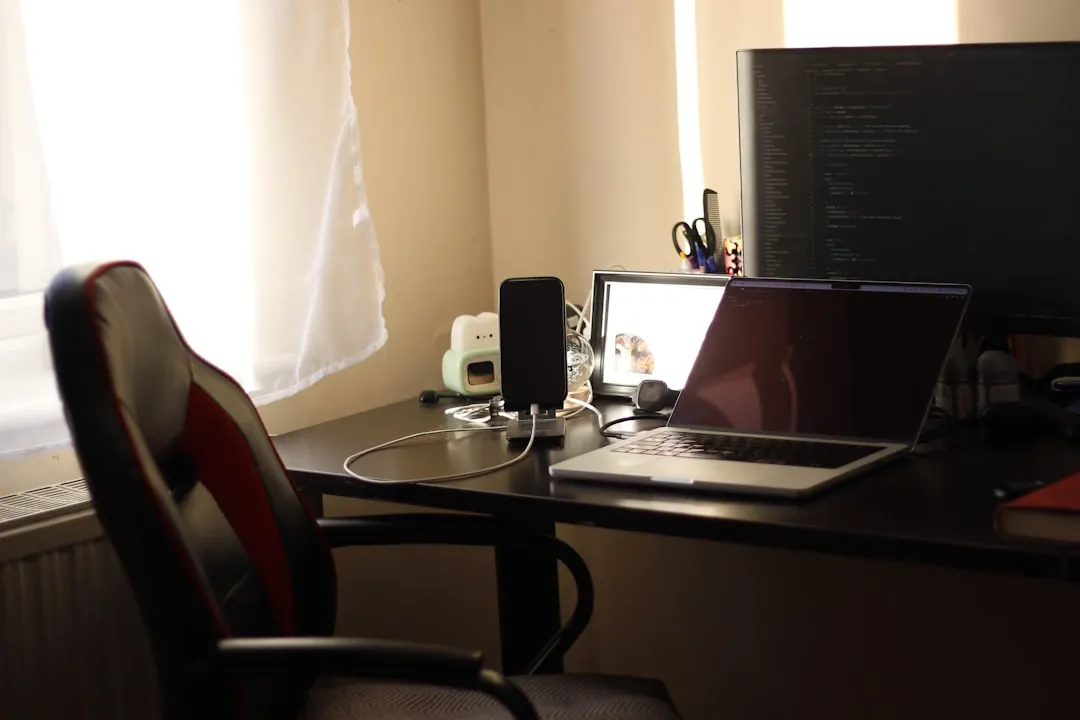 A desk with a laptop and a monitor on it
