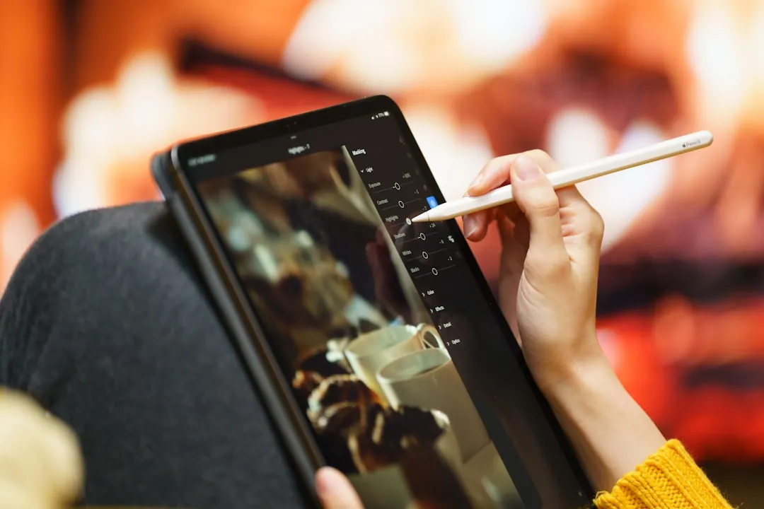 Someone is using a stylus on a tablet.