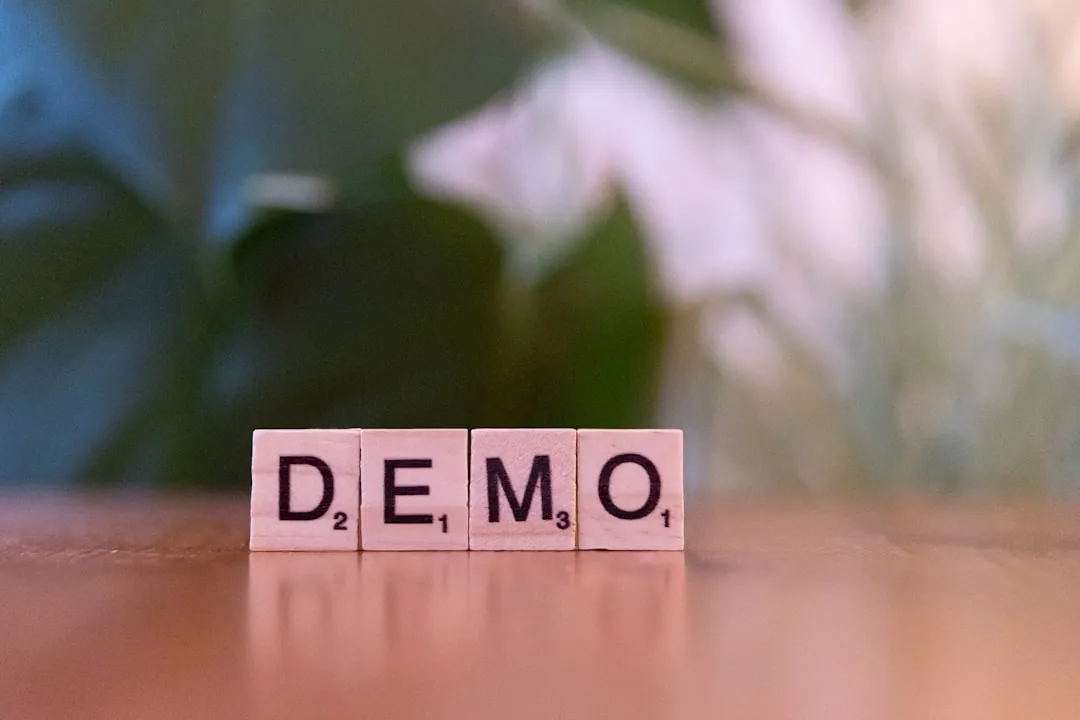 A close up of a wooden block with the word demo written on it